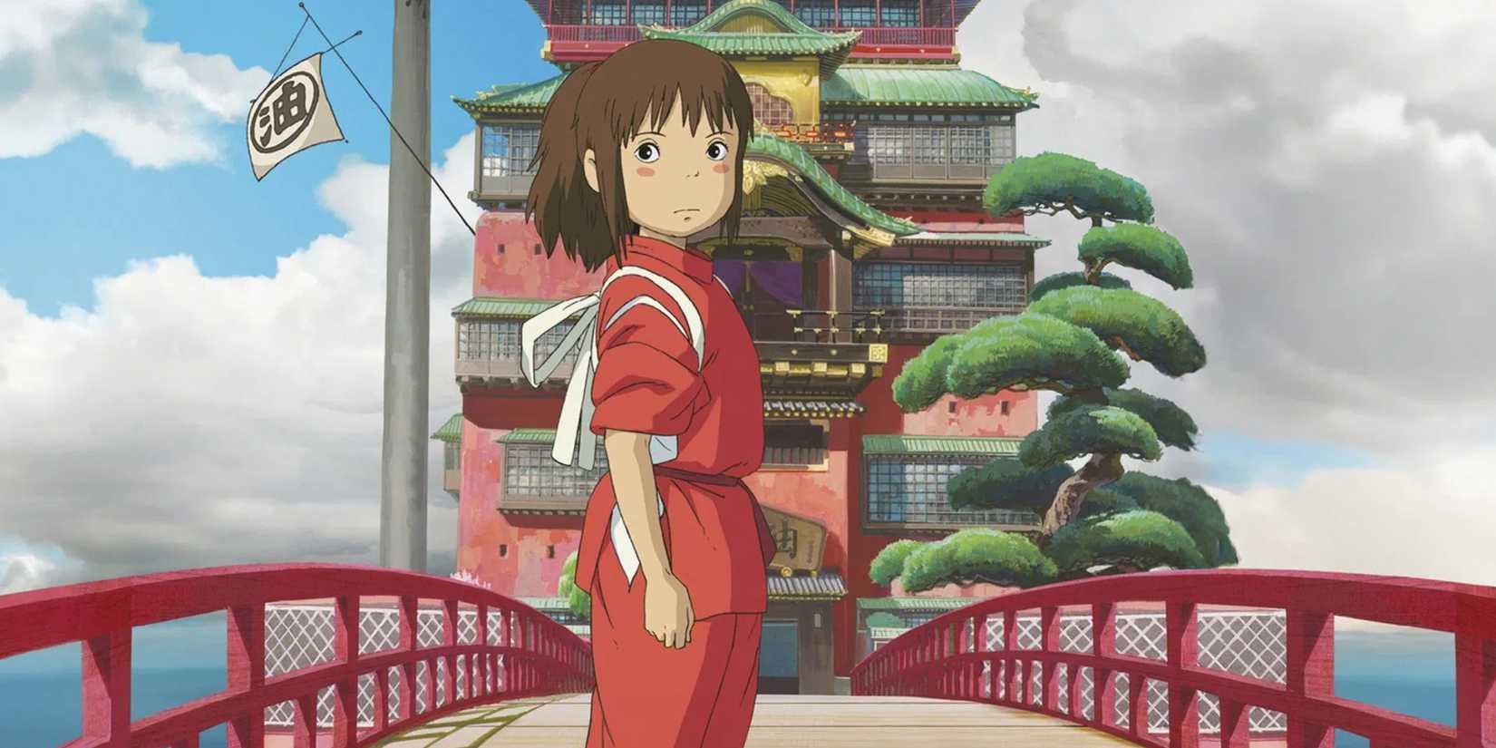 Chihiro standing in front of the spirit bathhouse in Spirited Away