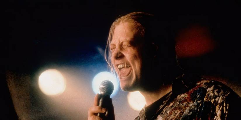 Deco Cuffe, played by actor Andrew Strong, sings on stage in The Commitments.