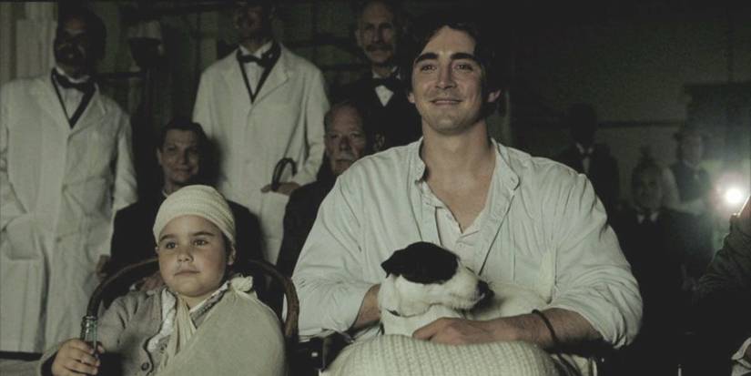 Lee Pace and a young girl smiling while looking ahead in The Fall