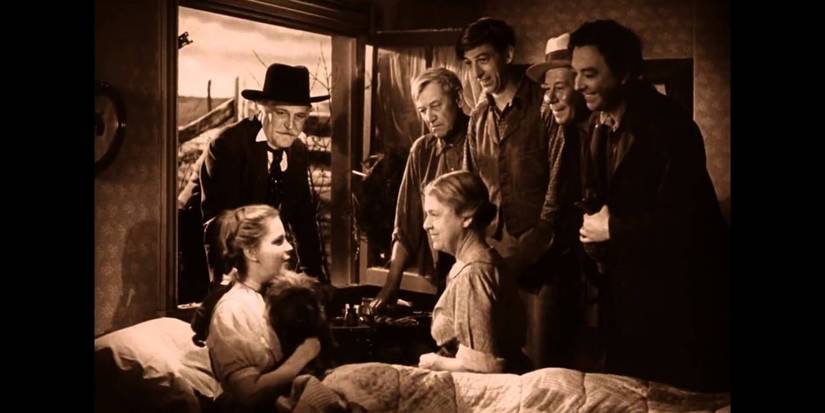 Dorothy in bed surrounded by friends in The Wizard of Oz