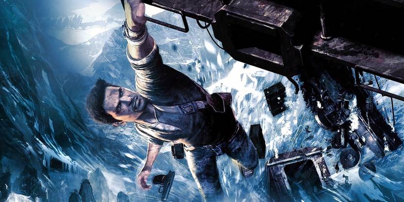 Nathan Drake dangling by one hand over the edge of a cliff in Uncharted 2: Among Thieves