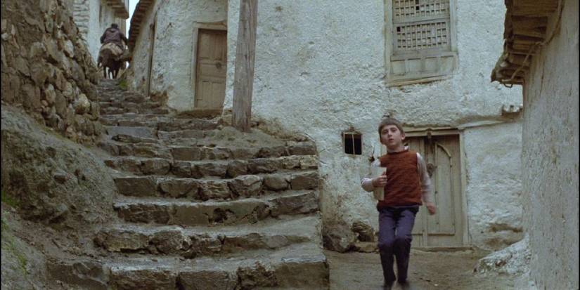 A young boy walking besides a flight of stairs Where is the Friend's House - 1987