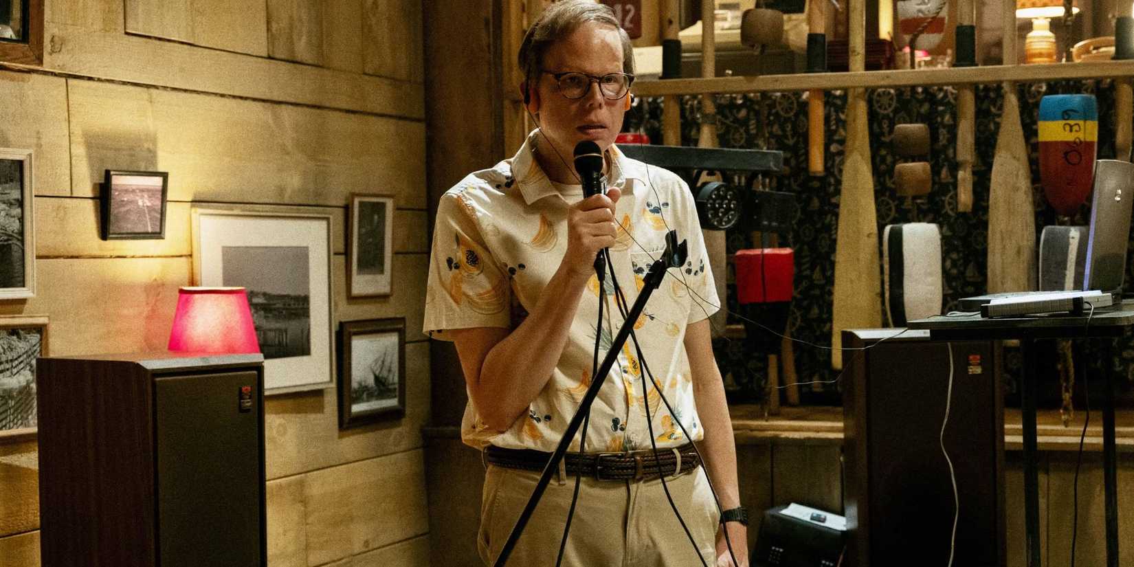 Jeff Hiller holding a microphone in 'Widow's Bay'