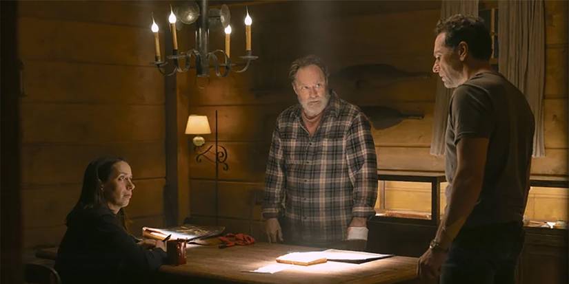 Kate, Wyck, and Tom meeting together in a dark room in Widow's Bay.