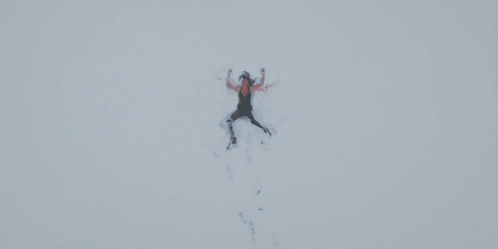 Woman lying bloodied in snow in 'Climax' (2018)