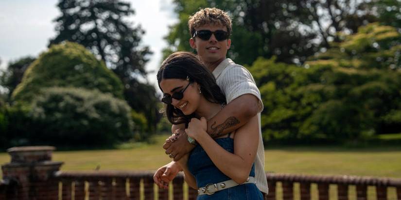 Matthew Broome as Nick with his arm around Asha Banks as Noah as they walk together in Your Fault: London