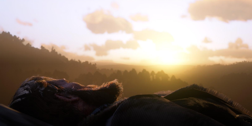 Arthur Morgan looking off at the sunrise as he succumbs to tuberculosis and dies in the ending of 'Red Dead Redemption 2' (2018)