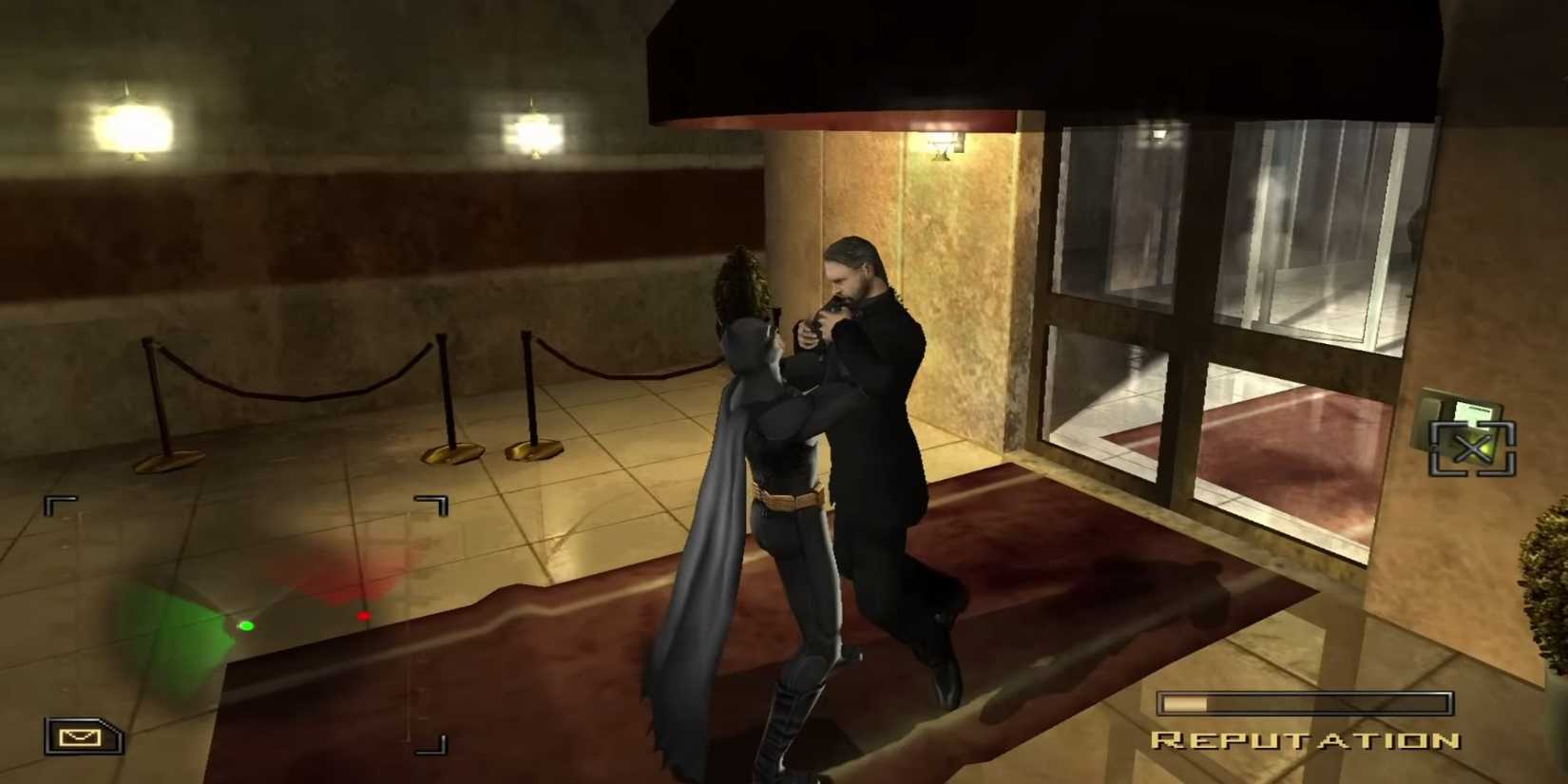 Batman holding a thug up by the collar in Batman Begins video game