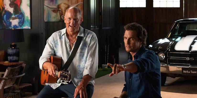 Matthew McConaughey and Woody Harrelson sitting and smiling while looking at something off screen in Brothers
