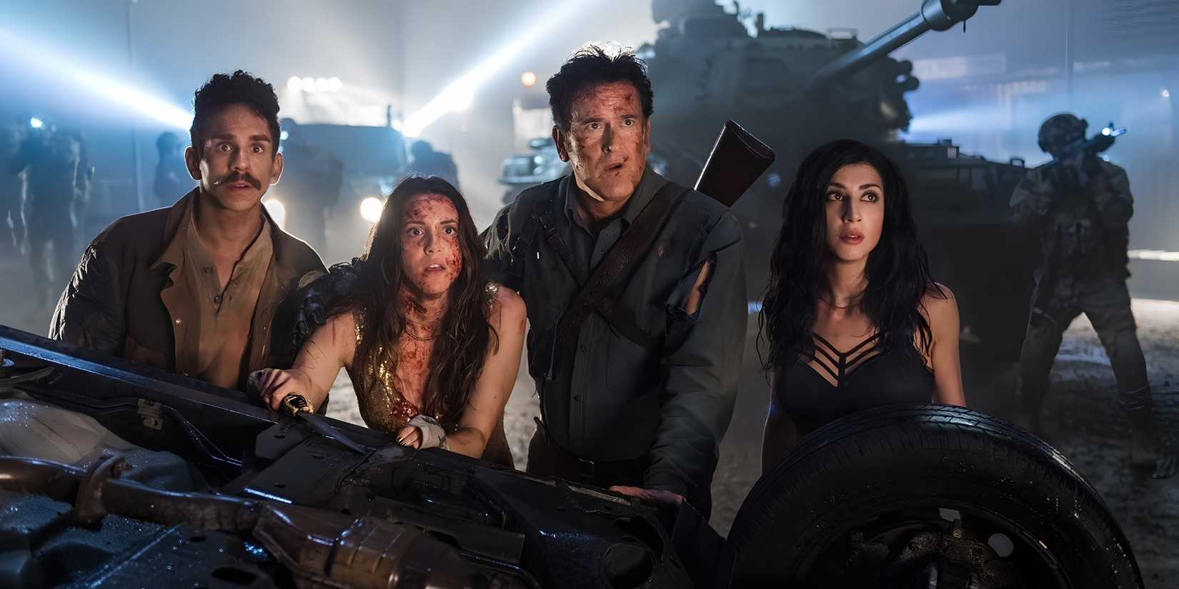 Ash (Bruce Campbell), Pablo (Ray Santiago), Brandy (Arielle Carver-O'Neill) and Kelly (Dana DeLorenzo) behind an overturned car in Ash vs Evil Dead.