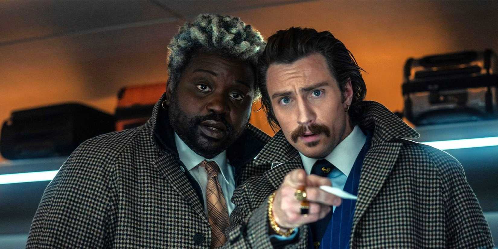 Brian Tyree Henry and Aaron Taylor-Johnson looking towards the camera in Bullet Train