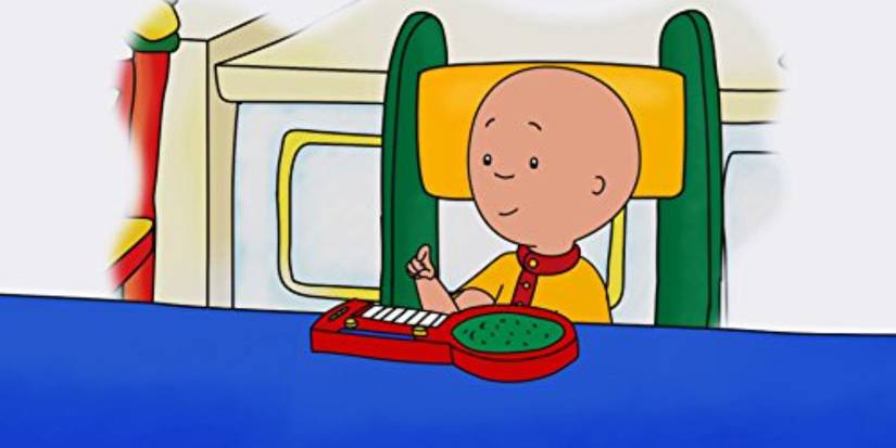 Caillou sitting at the table in 'Caillou'