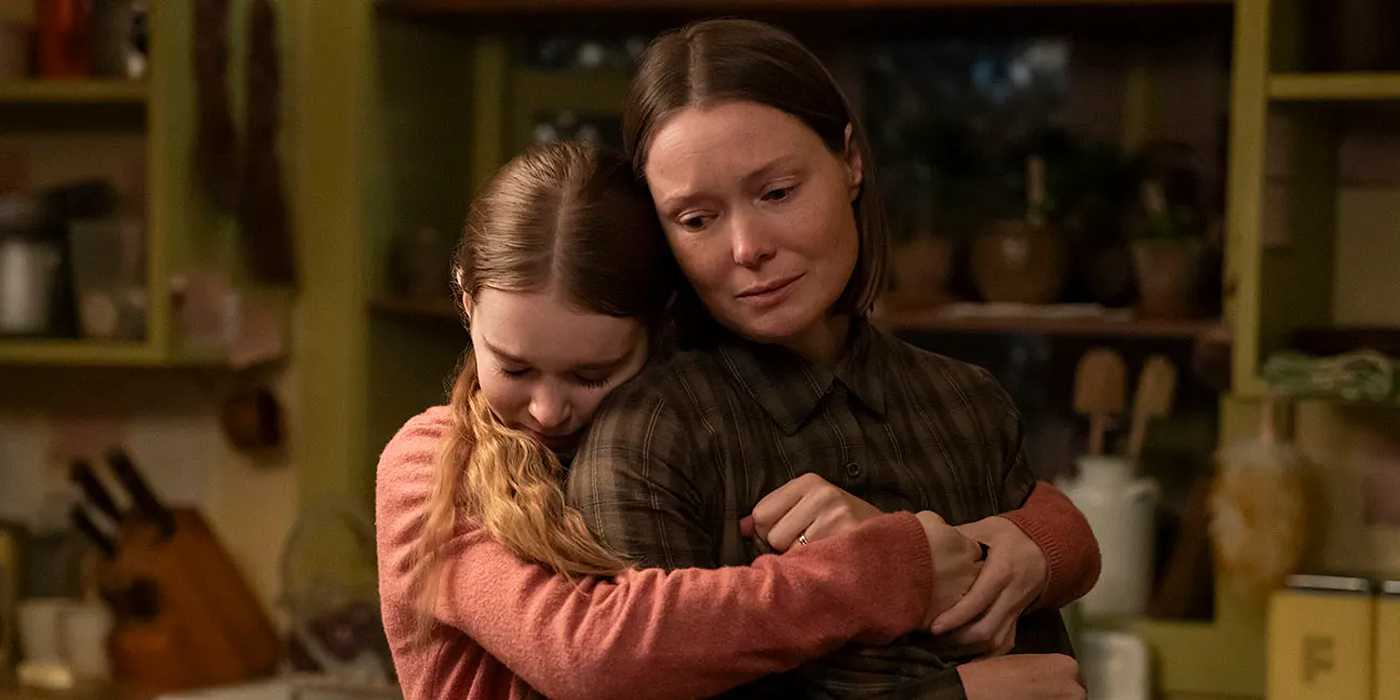 Summer H. Howell hugging Samantha Sloyan from behind in Carrie