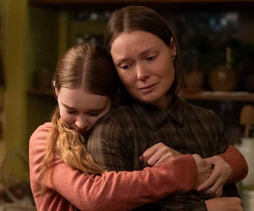 Summer H. Howell hugging Samantha Sloyan from behind in Carrie