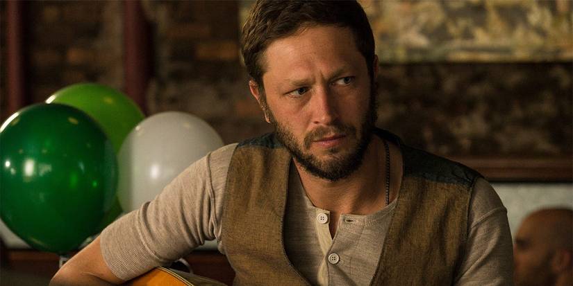 Desi playing the guitar in Girls.