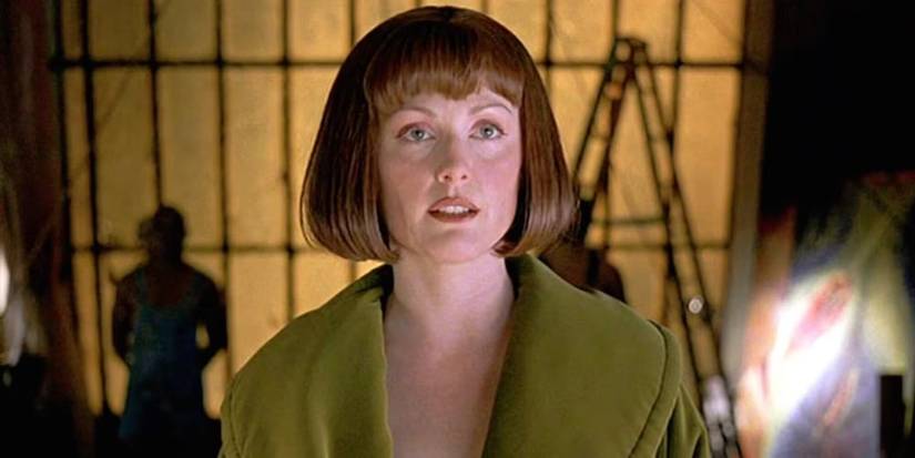Julianne Moore as Maude Lebowski standing in front of art looking past the camera in The Big Lebowski, 1998.