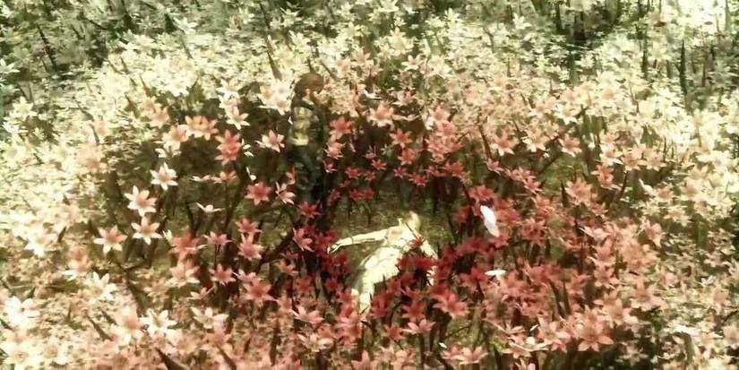 Big Boss standing over The Boss in a field of white flowers turning red after ending her life in 'Metal Gear Solid 3: Snake Eater' (2004)