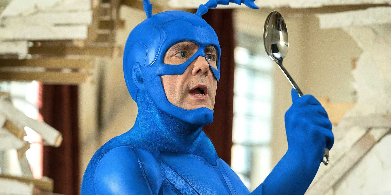 The Tick looking at his reflection in the back of a spoon.