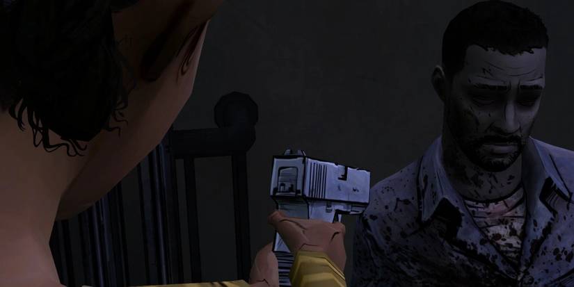 Clementine holding up a pistol to Lee to put him out of his misery in the ending to Telltale's The Walking Dead (2012)