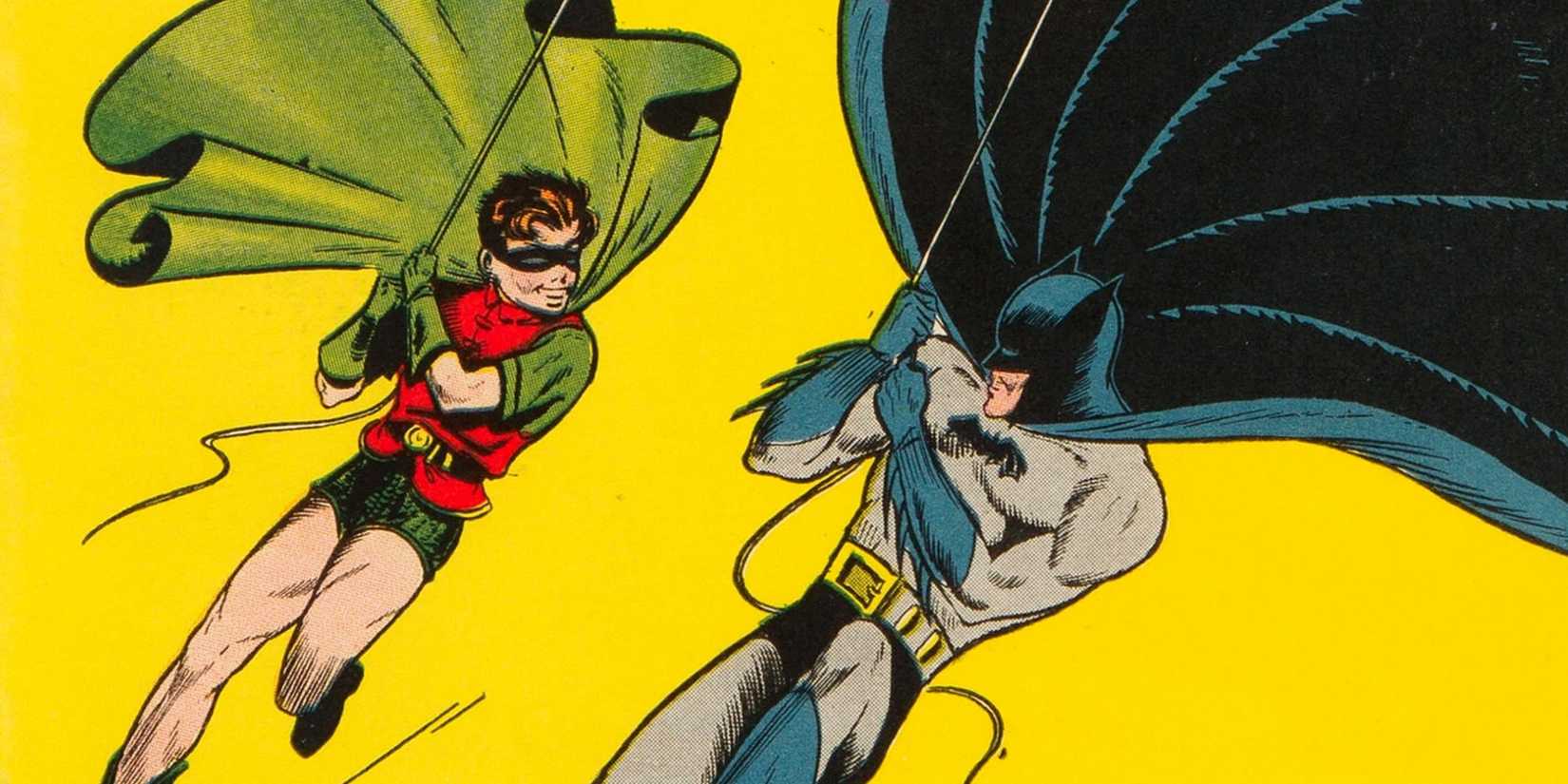 Batman and Robin swing above Gotham on the cover of Batman #1 (1940)