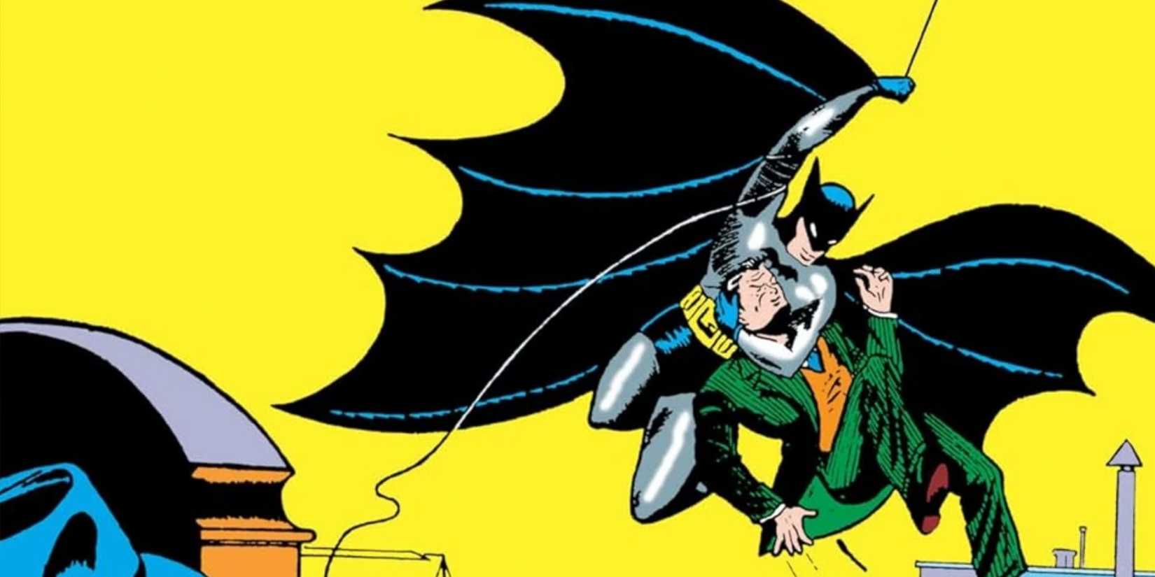 Batman carries a criminal on the cover of Detective Comics #27 (1939)