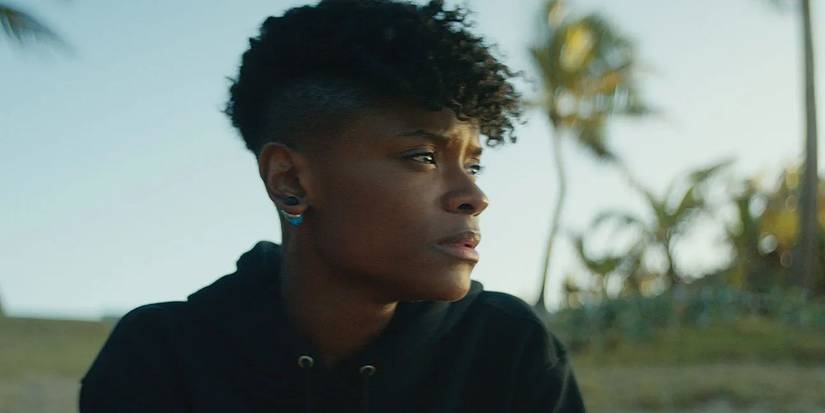Shuri (Letitia Wright) sitting on a beach at the end of 'Black Panther: Wakanda Forever'
