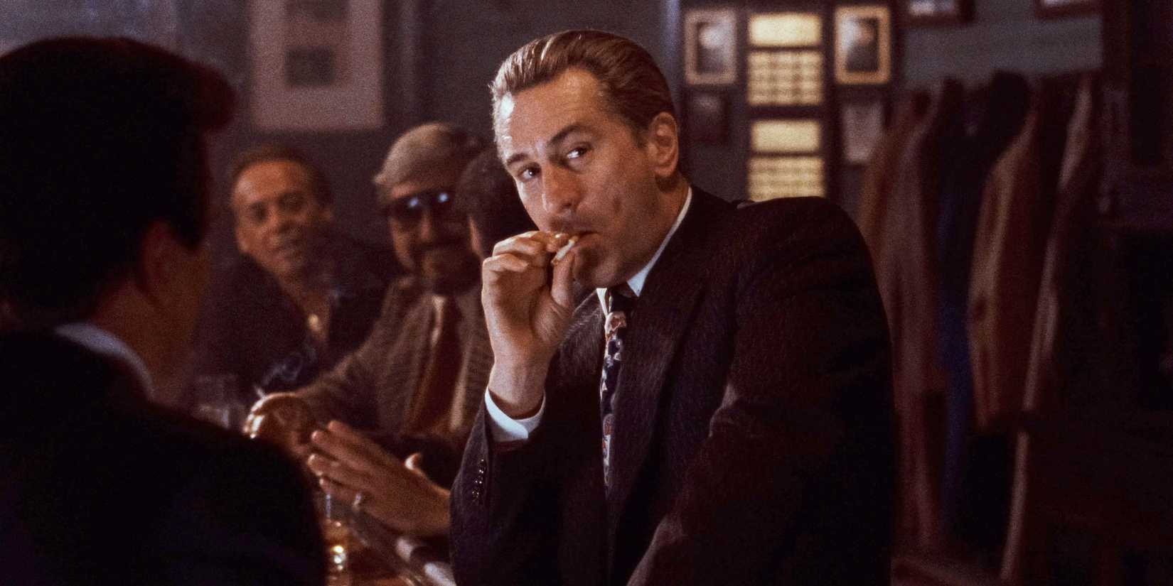 Robert De Niro as James "Jimmy" Conway smoking a cigarette during a bar scene in Goodfellas (1990)