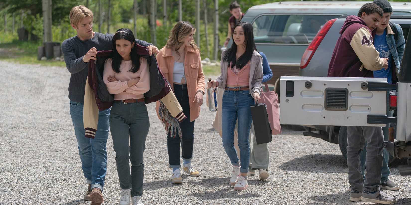 Noah LaLonde as Cole and Nikki Rodriguez as Jackie and their friends at the lake house in 'My Life with the Walter Boys.'