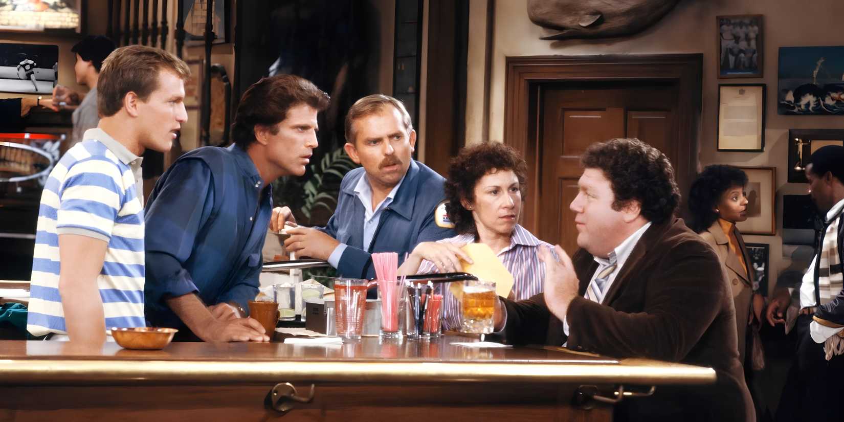 Norm (George Wendt) tells a captivating story from his barstool in Cheers.