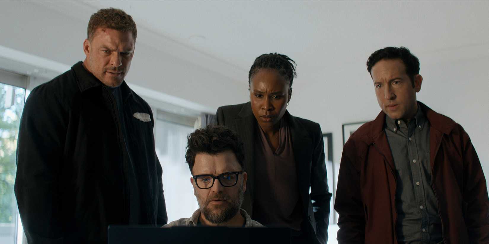 The cast of Reacher Season 4 looking at a computer screen