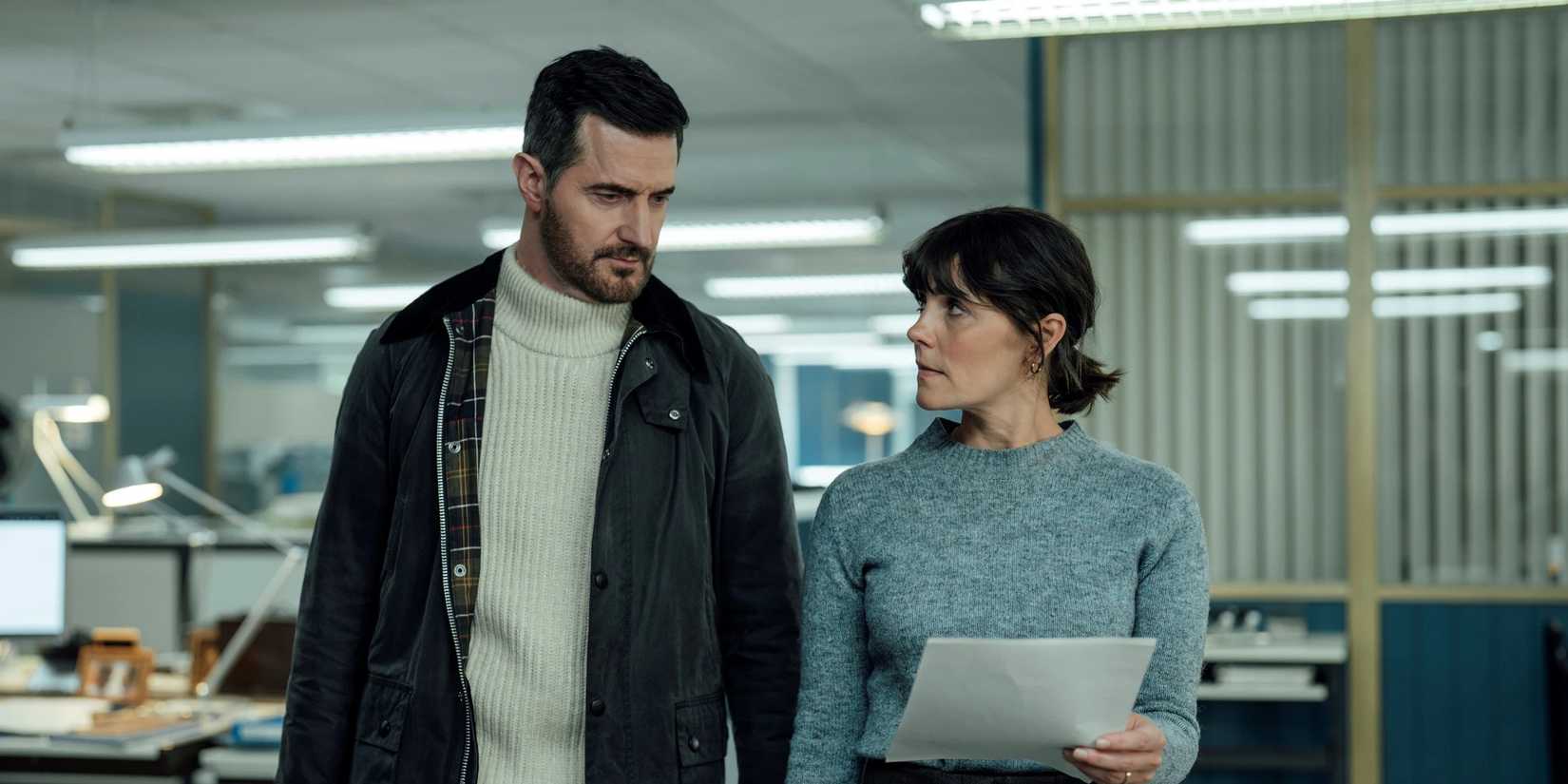Richard Armitage and Annebel Scholey looking at a sheet of paper in 'Winter'