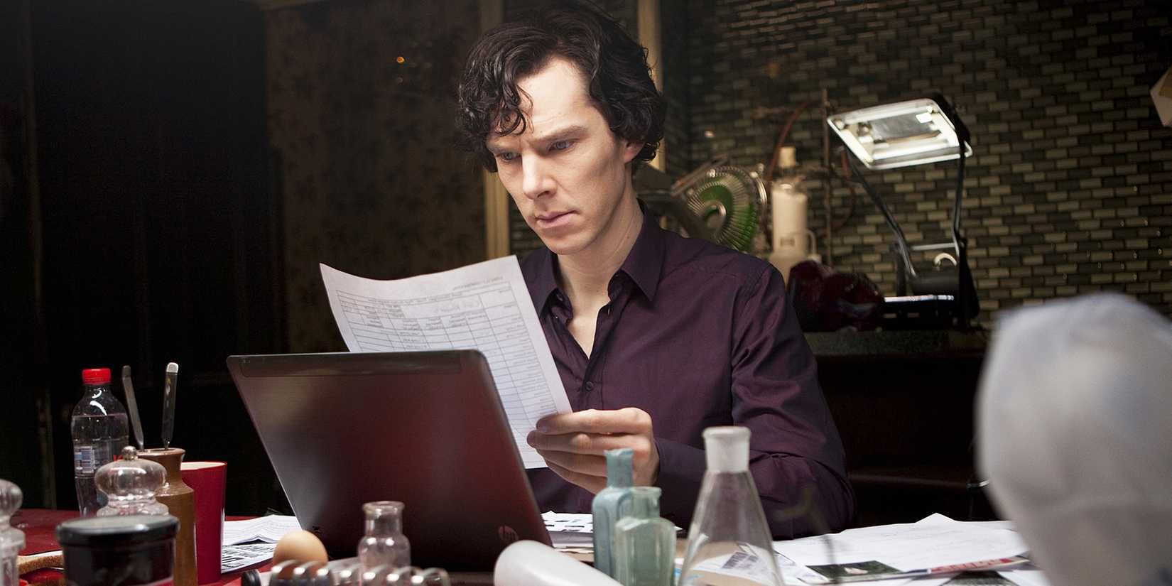 Sherlock Holmes (Benedict Cumberbatch) looking at a document in the BBC series 'Sherlock'