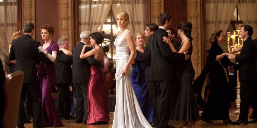 A woman in white dress looks distressed in the middle of the room