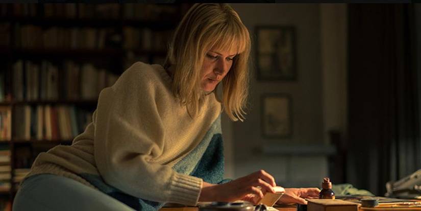 Agnieszka Żulewska looking at files at a desk in the Polish series The Mire