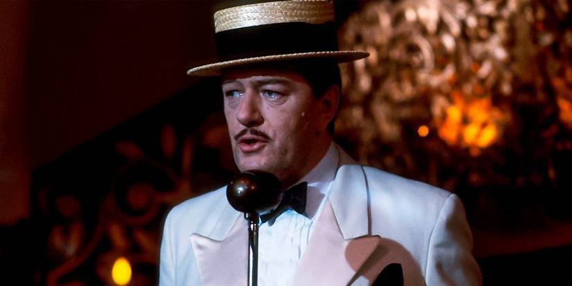 Michael Gambon as the suave Singing Detective singing into a vintage microphone in the 1986 film