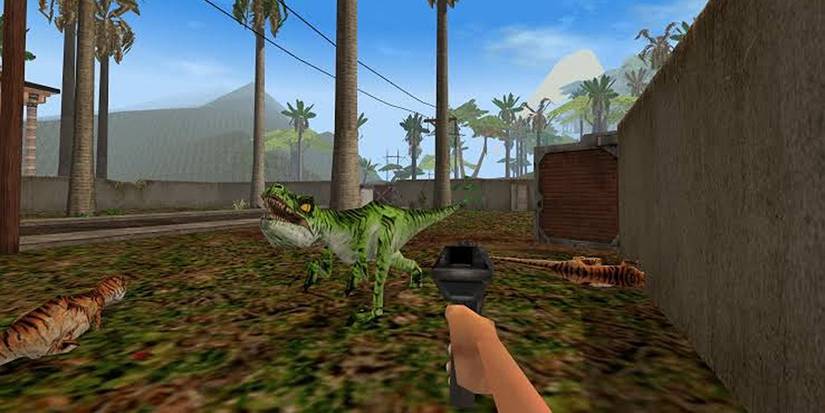 First-person screenshot from the 1998 video game Jurassic Park: Trespasser showing a player aiming a handgun at a green Velociraptor dinosaur.