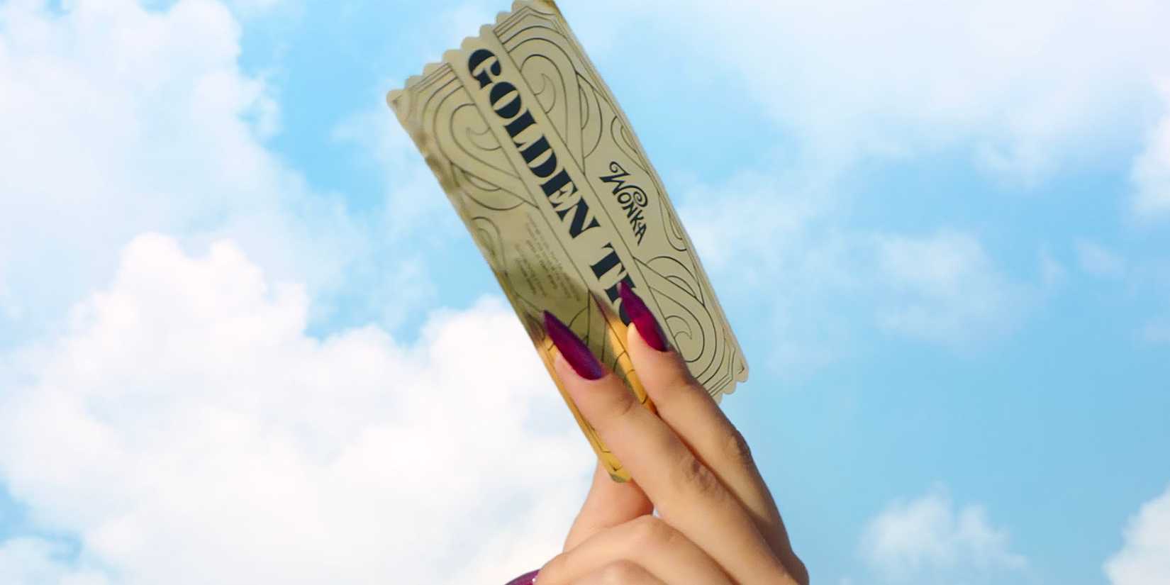 A woman holding a Golden Ticket as a promo image for Wonka's Golden Ticket.