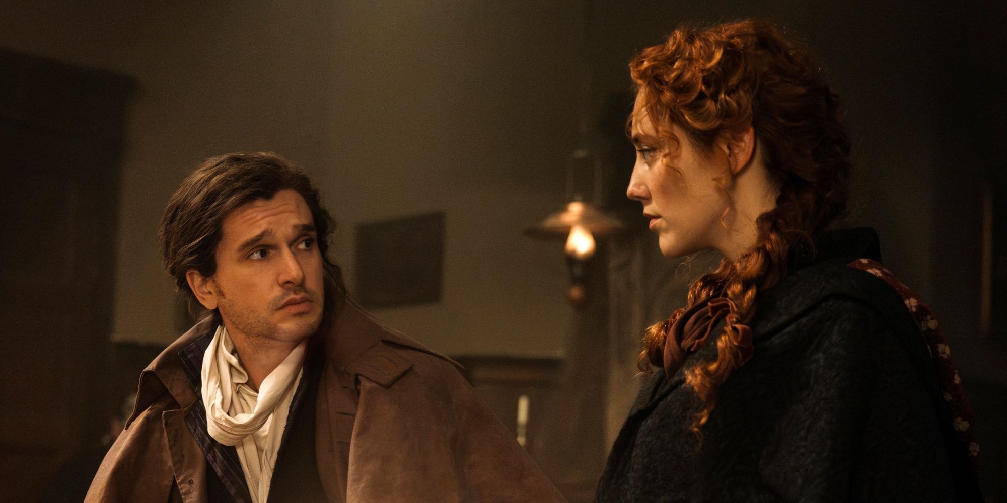 Kit Harington as Sydney Carton standing next to and looking at Mirren Mack as Lucie in A Tale of Two Cities