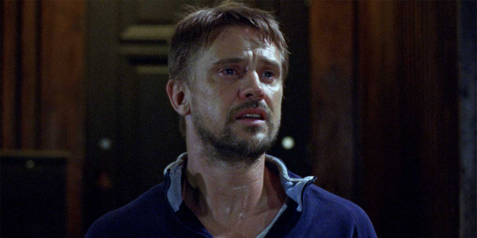 Boyd Holbrook as Lou D'Alessandro looking distraught in Atonement