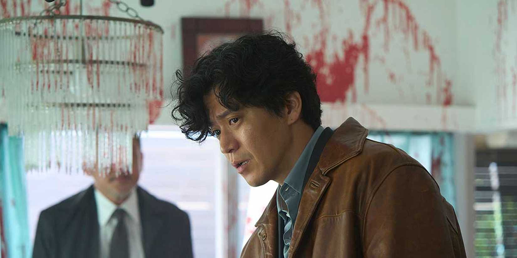 Shun Oguri looking at a crime scene in a still from Bad Lieutenant: Tokyo
