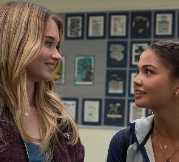 Alison Thornton and Siena Agudong smiling at each other as Chris Hargensen and Sue Snell in Carrie.