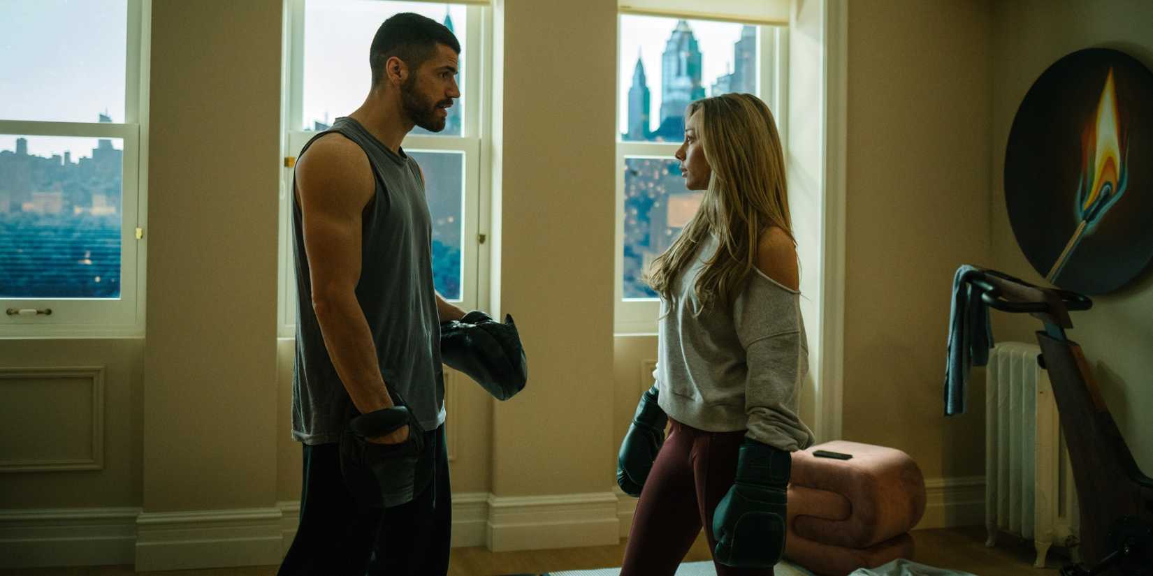 Hugo Diego Garcia as Sebastian wearing boxing gloves with Ester Exposito as Marfil in Drawn Together