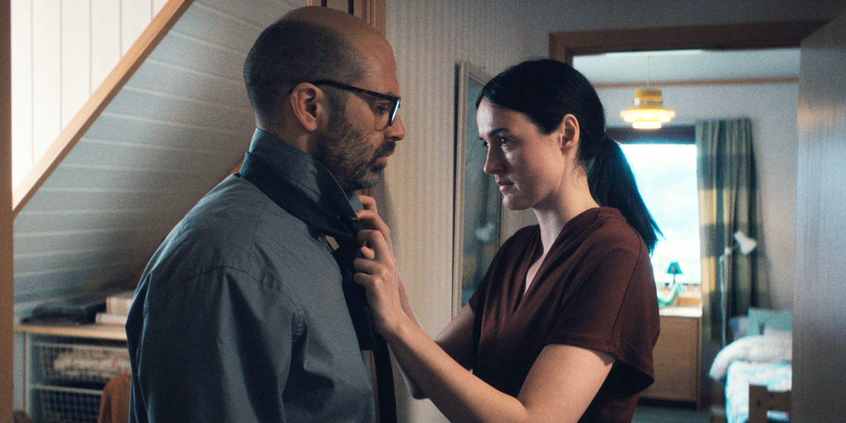 A woman straightens a man's tie.