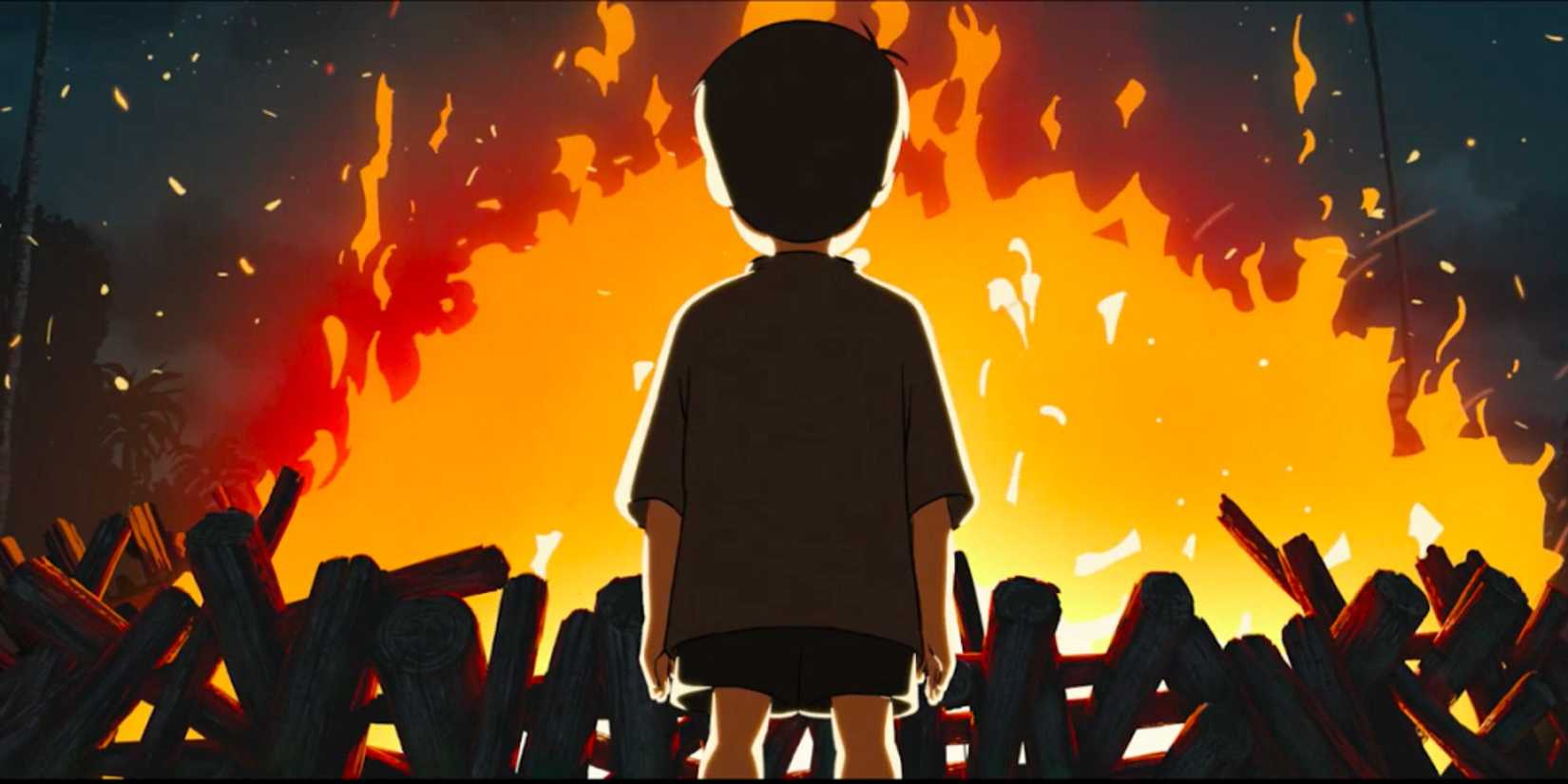 A young boy stands in front of a large bonfire 'Funan'