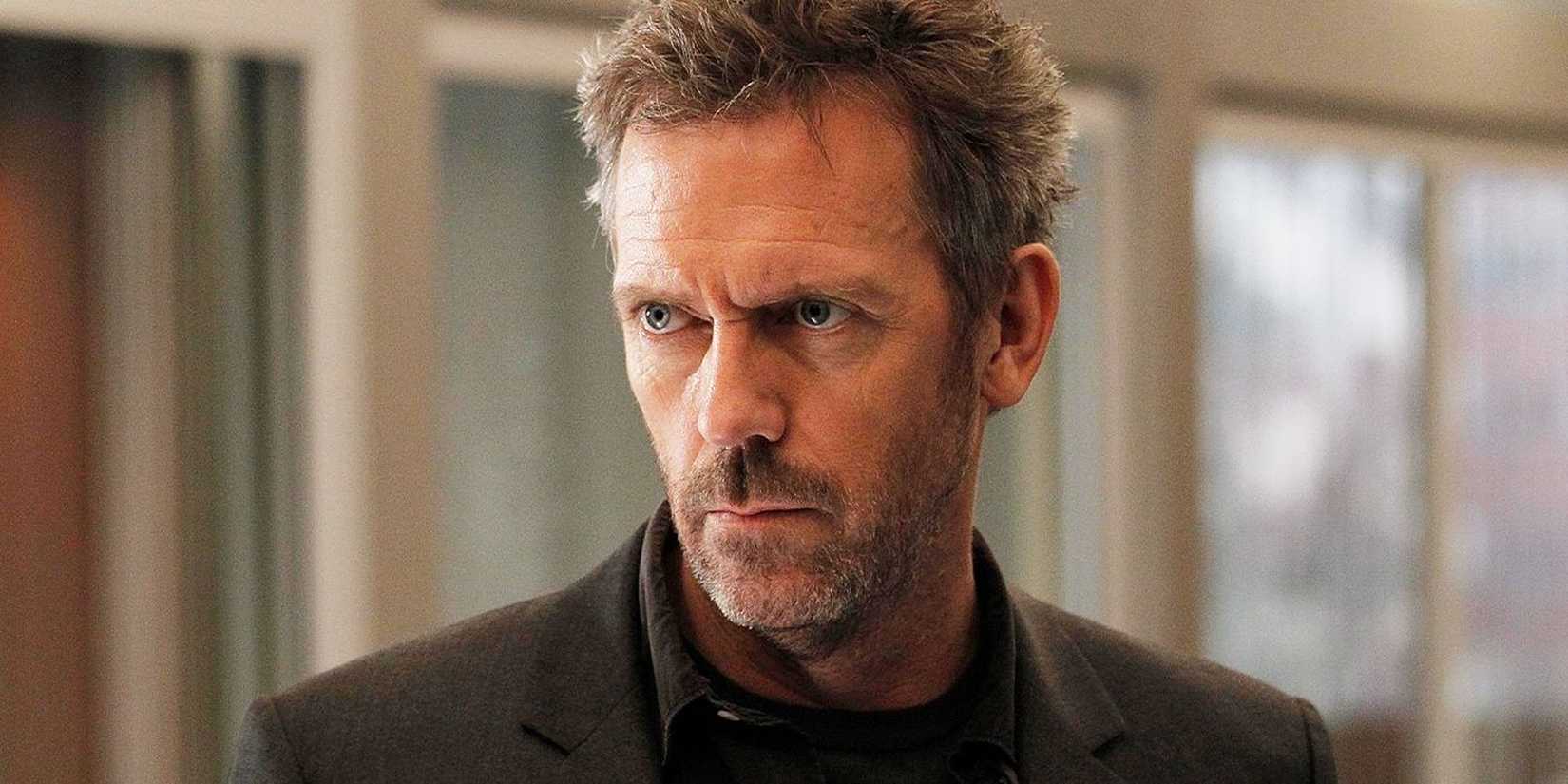 Hugh Laurie looking to the side with a serious expression in House