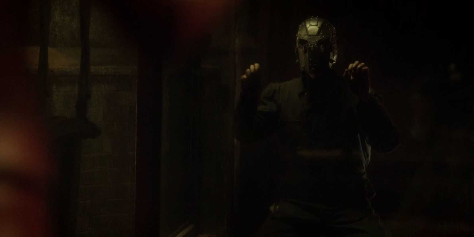 Jay Garrick with a mask on in a prison cell, banging on it in The Flash Season 2, Episode 14