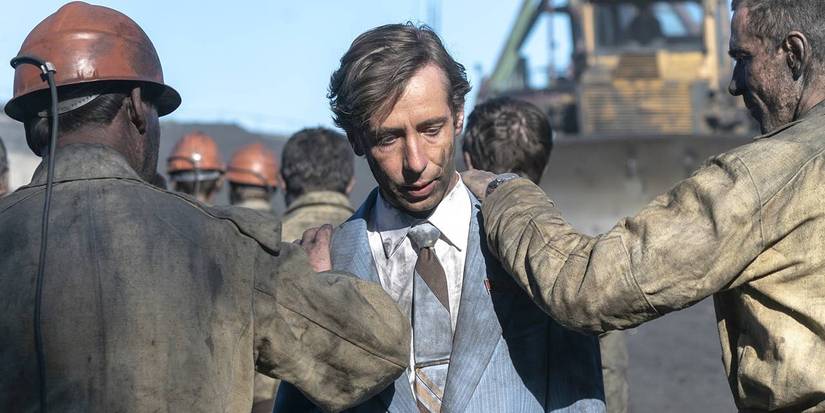 Emergency workers with their hands on Michael Colgan's shoulders in 'Open Wide, O Earth' from 'Chernobyl'