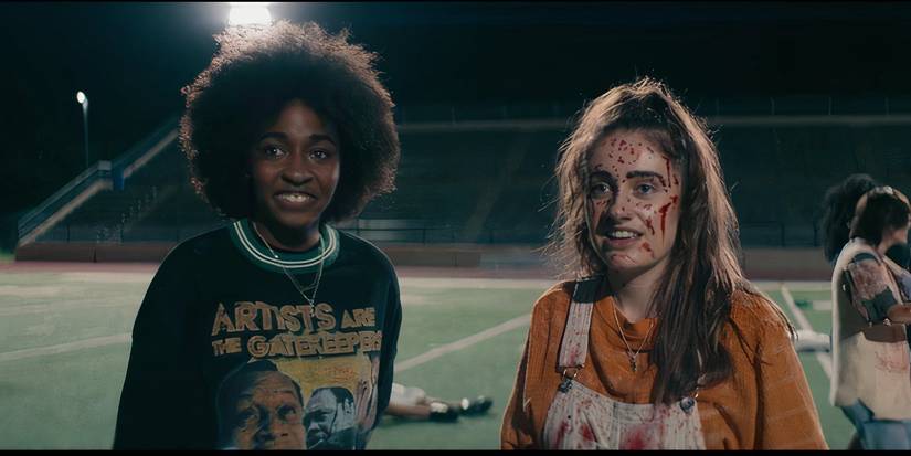 Ayo Edebiri and Rachel Sennott covered in blood at the end of Bottoms.