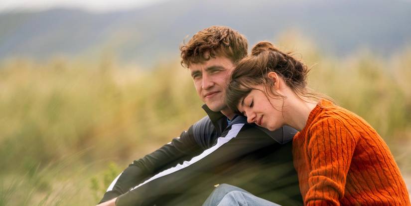 Connell and Marianne sitting together in a field in 'Normal People'