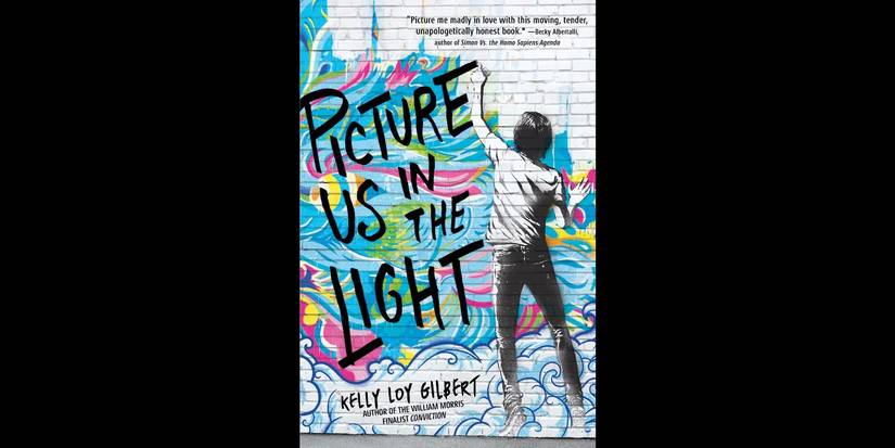 The book cover for Picture Us in the Light by Kelly Loy Gilbert over a black background